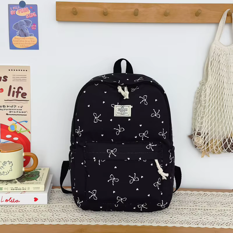 Sac à dos pour adolescents avec un joli imprimé nœud papillon, ultra léger, spacieux et polyvalent, 